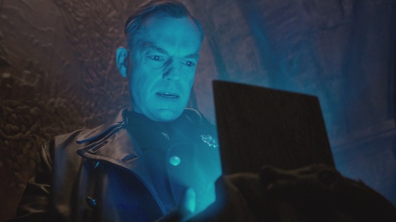 Hugo Weaving as Johaan Schmidt staring into a box emitting a blue glow in Captain America: The First Avenger