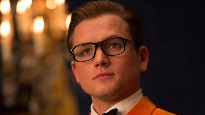 Taron Egerton as Eggys in his orange suit in Kingsman: The Golden Circle