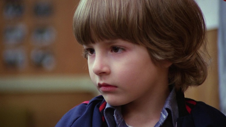 Danny Lloyd as Danny Torrance looking to the side in The Shining