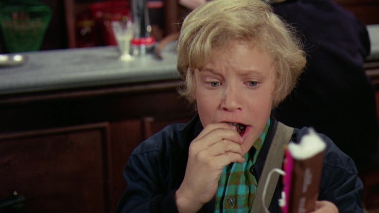 Peter Ostrum as Charlie Bucket eating chocolate in Willy Wonka & the Chocolate Factory