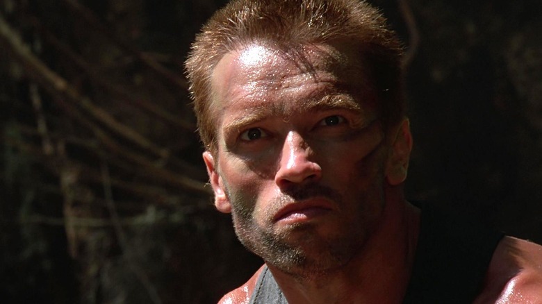 Arnold Schwarzenegger as Dutch Schaefer staring ahead in Predator