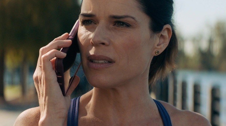 Neve Campbell as Sidney Prescott speaking on the phone in 2022's Scream