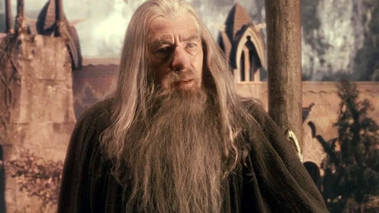 Ian McKellen as Gandalf who is standing outside and looking toward the right in Lord of the Rings