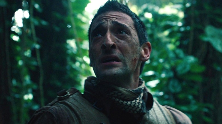 Adrien Brody as Royce looking scared in the jungle in Predators