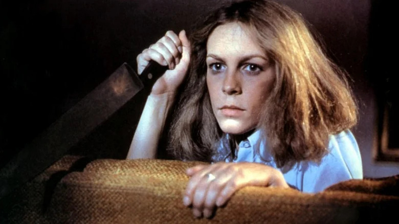 A young Jamie Lee Curtis holding a knife in "Halloween"