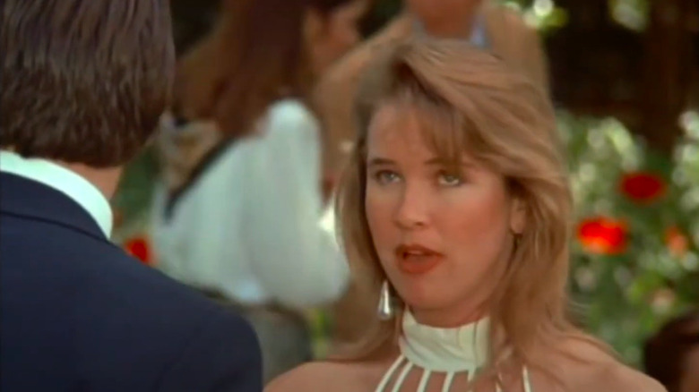 A young Renée Zellweger wearing dress and talking to man in "A Taste for Killing"