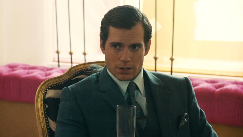 Henry Cavill as Napoleon Solo wearing a suit and talking in The Man from U.N.C.L.E.