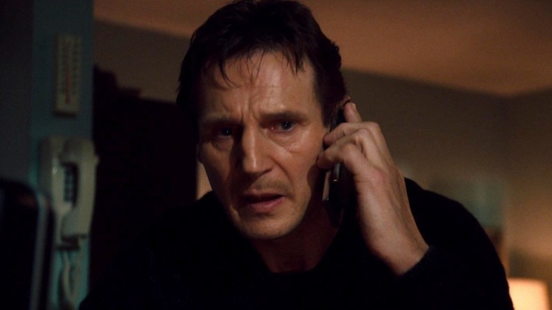 Liam Neeson as Bryan Mills holding the phone to his ear in Taken