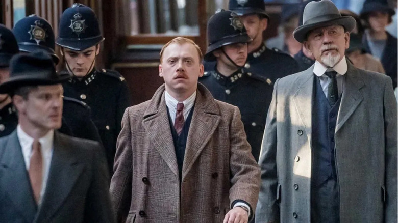 Hercule Poirot (John Malkovich) walking with Inspector Crome (Rupert Grint) in The ABC Murders