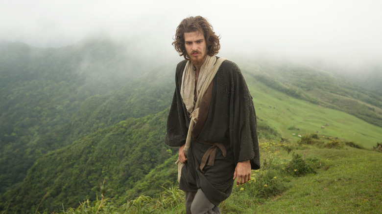 Andrew Garfield as Rodrigues walking over mountain in Silence