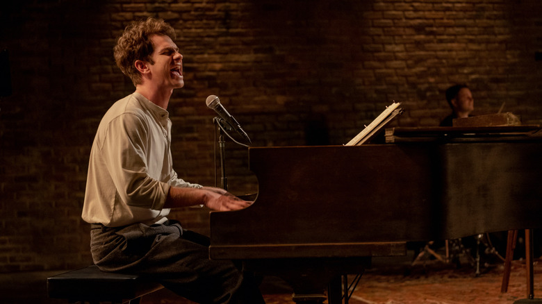 Andrew Garfield as Jonathan Larson performing at piano in tick tick BOOM!