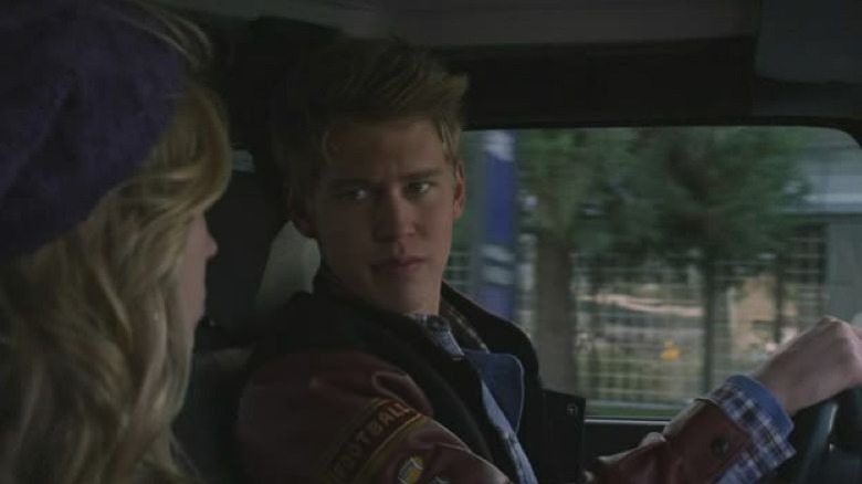 Austin Butler as Jones Mager sitting in the driver's seat of the car staring at his blonde-haired passenger in Life Unexpected.