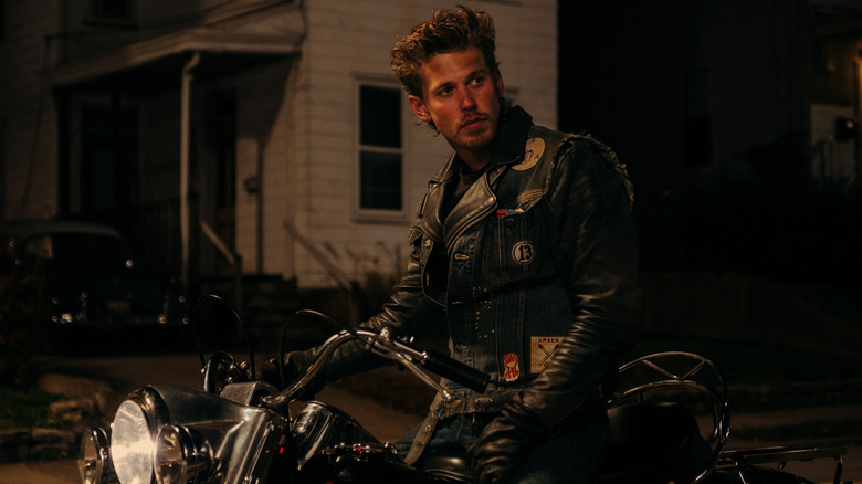 Austin Butler as Benny Cross sitting on a motorcycle in The Bikeriders