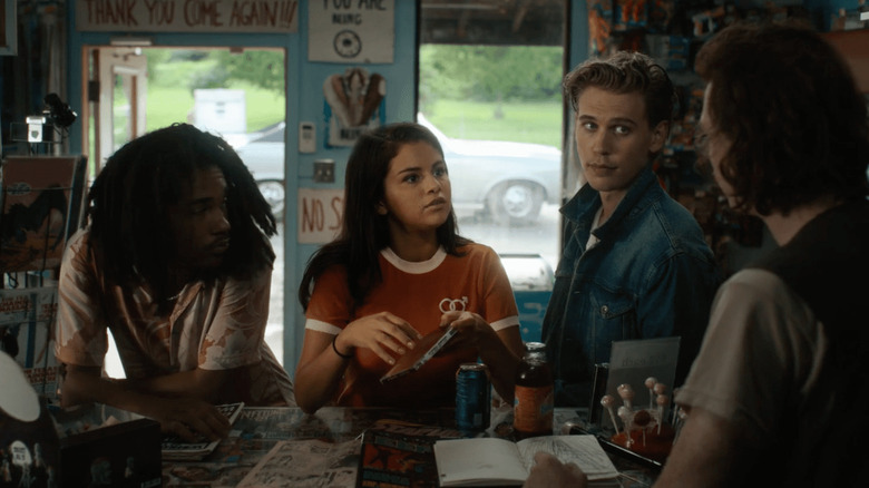 Luka Sabbat as Zack, Selena Gomez as Zoe, and Austin Butler as Jack standing at the counter of a convenience store in The Dead Don't Die.