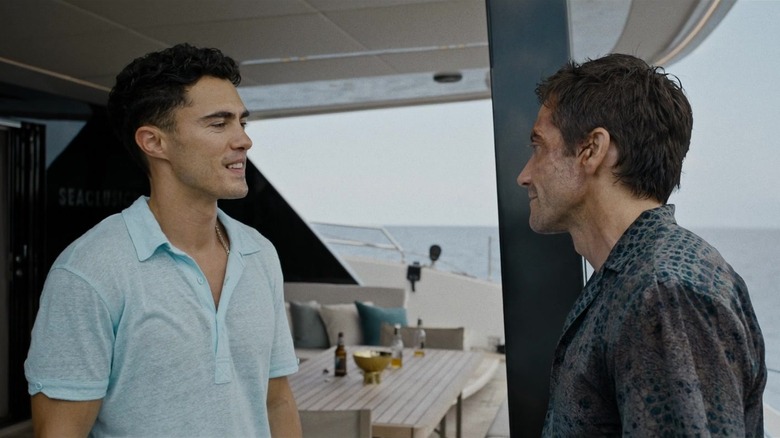 Darren Barnet and Jake Gyllenhaal as Sam and Dalton confronting each other on a boat in 2024's Road House