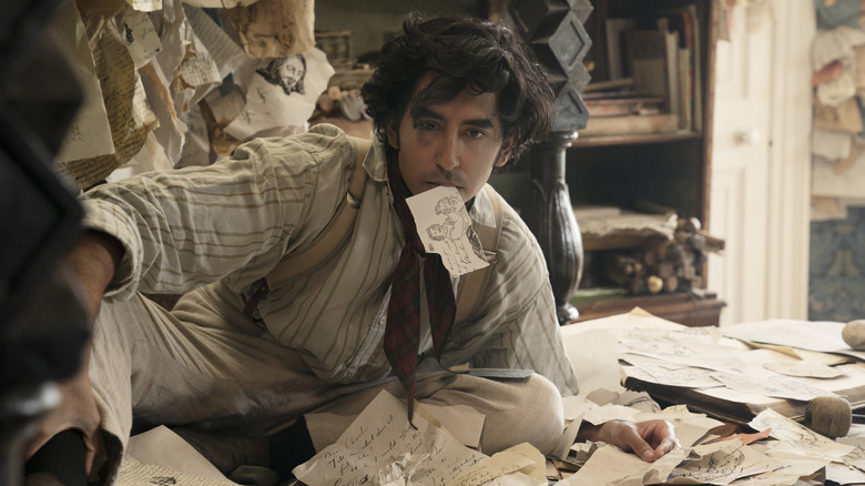 David Copperfield surrounded by scraps of paper in The Personal History of David Copperfield