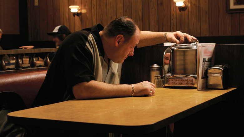 James Gandolfini as Tony, flipping through a table jukebox on the sopranos