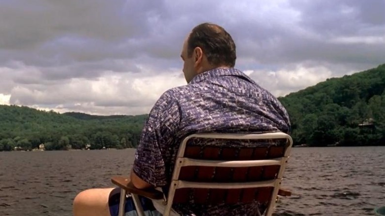 James Gandolfini as Tony, sitting in a chair by the lake on the Sopranos