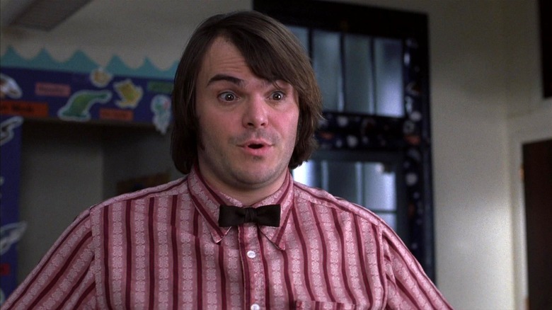 Jack Black as Dewey Finn wearing a bowtie and speaking in School of Rock