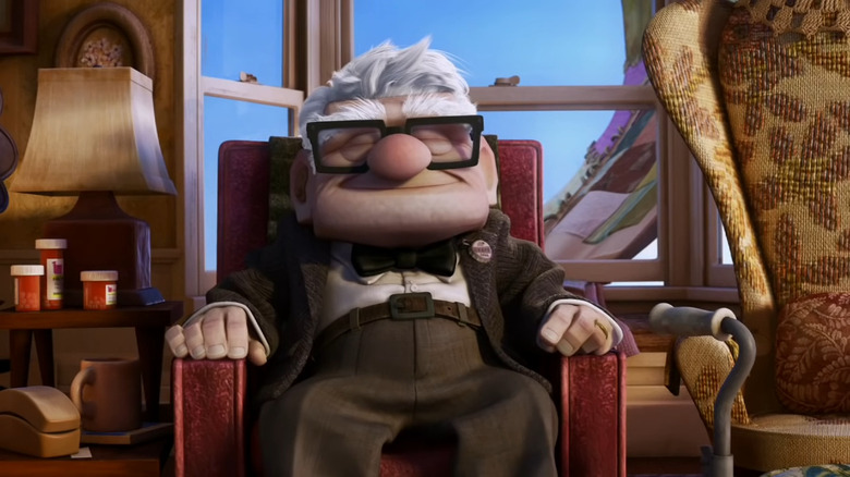 Carl Fredricksen sitting in his chair and smiling in Up