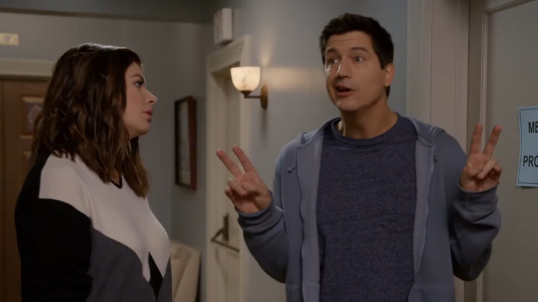 Casey Wilson and Ken Marino as Annie and Jake joking around in a hallway on the NBC TV show Marry Me