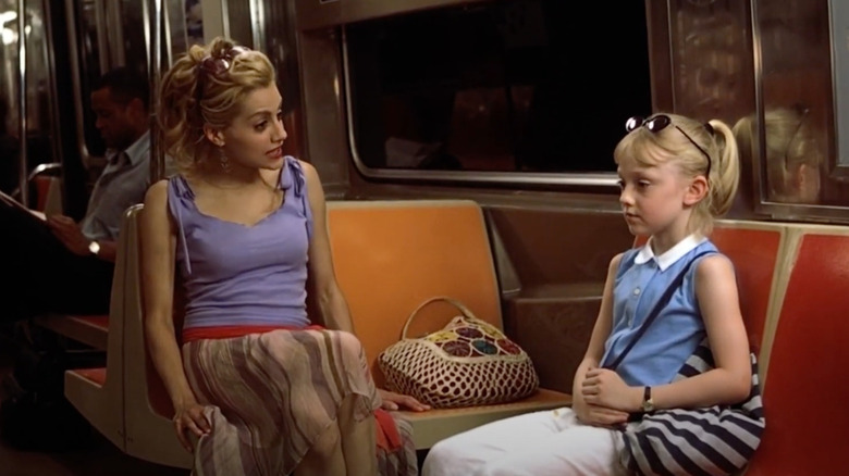 Brittany Murphy as Molly Gunn sits on the subway with Dakota Fanning as Ray in Uptown Girls