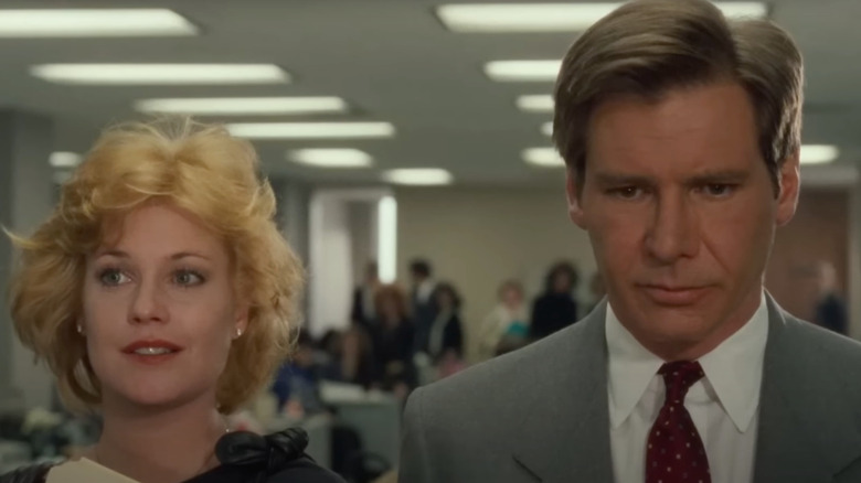 Melanie Griffith as Tess McGill smiles next to Harrison Ford as Jack Trainer in Working Girl