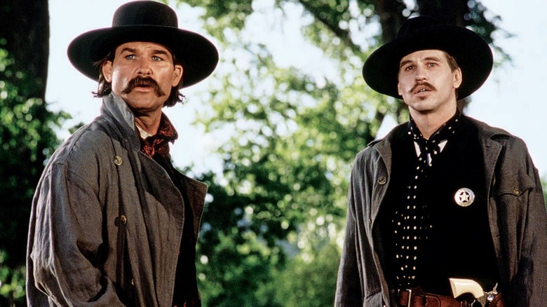 Wyatt Earp (Kurt Russell) and Doc Holliday (Val Kilmer) look concerned in Tombstone