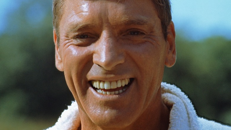 Neddy Merrill grinning in a close-up in The Swimmer