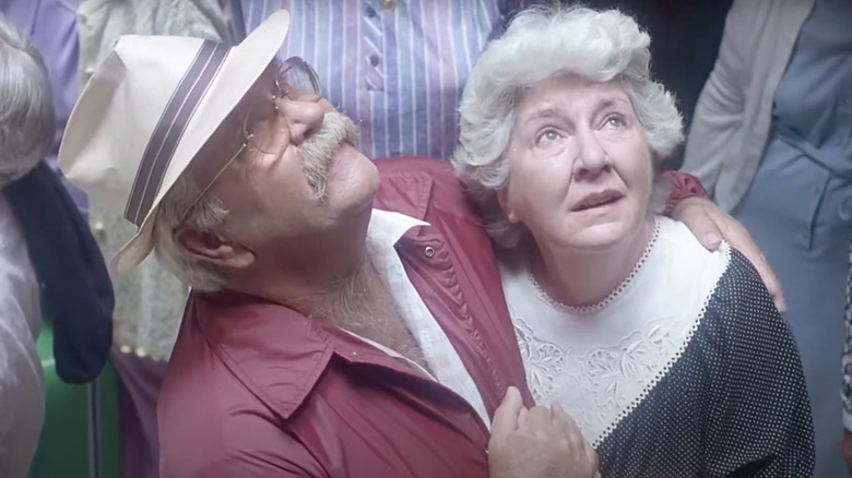 Wilford Brimley as Ben Luckett and Maureen Stapleton as Mary Luckett look up at a light in Cocoon