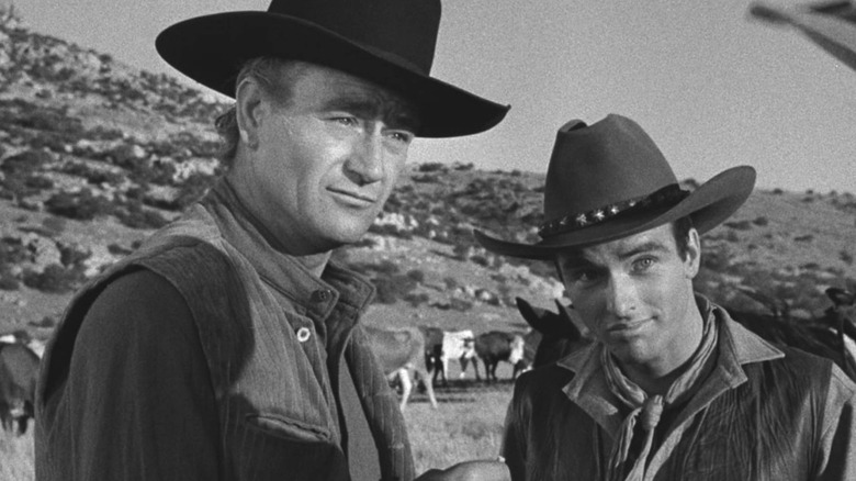 Tom Dunson (John Wayne) and Matt Garth (Montgomery Clift) listen in in Red River