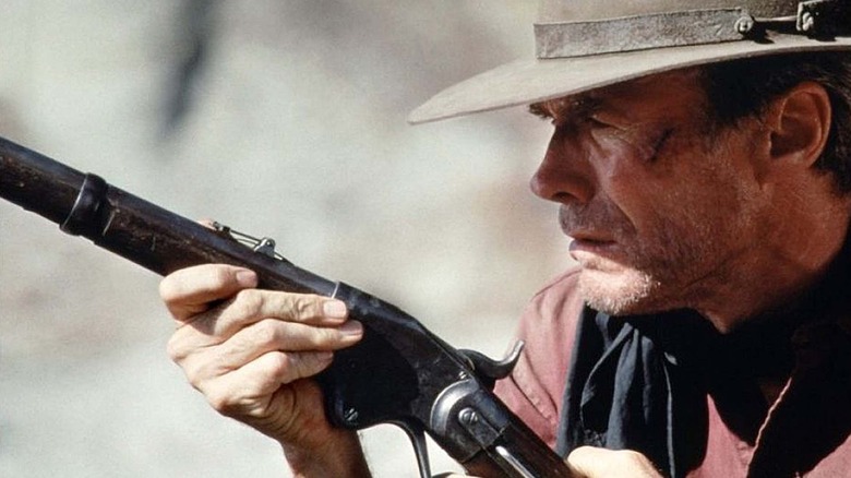 Will Munny (Clint Eastwood) aiming rifle in Unforgiven