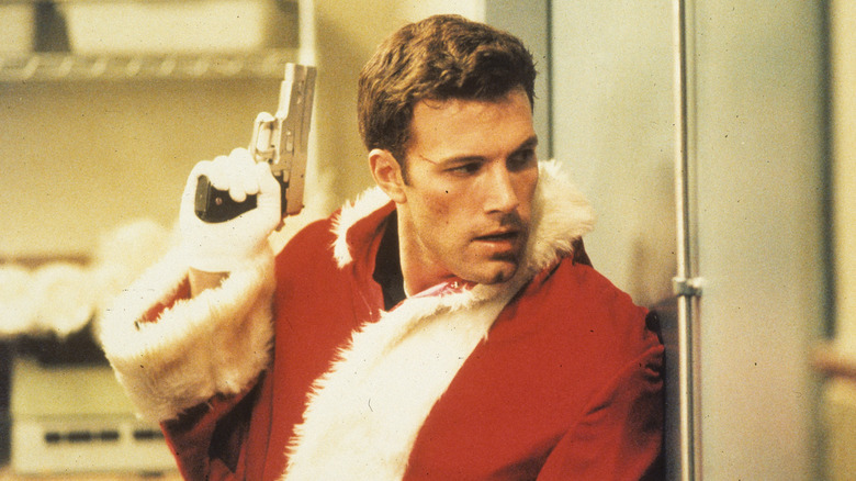 Rudy Duncan wears a Santa suit and brandishes a gun in Reindeer Games