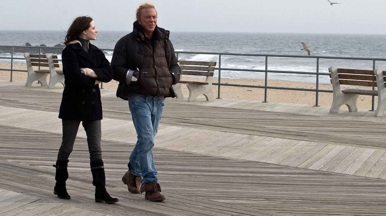 Stephanie and Randy in their winter coats walking on the boardwalk In The Wrestler