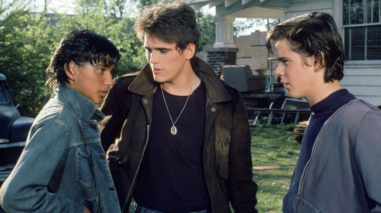 Johnny (Ralph Macchio), Dallas (Matt Dillion), and Pony Boy (C. Thomas Howell) talk in The Outsiders