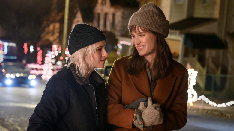 Abby and Harper in coats walking down the street in Happiest Season