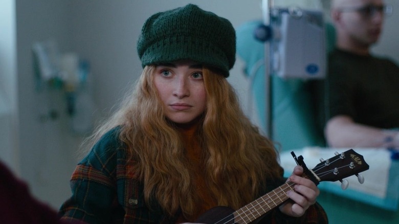 Sabrina Carpenter as Sammy holding a ukelele in Clouds