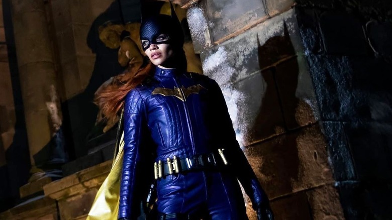 Leslie Grace as Batgirl standing in an alley with hair blowing in wind