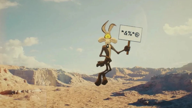 Wile E. Coyote holding a sign over a cliff for the unreleased Coyote vs. Acme