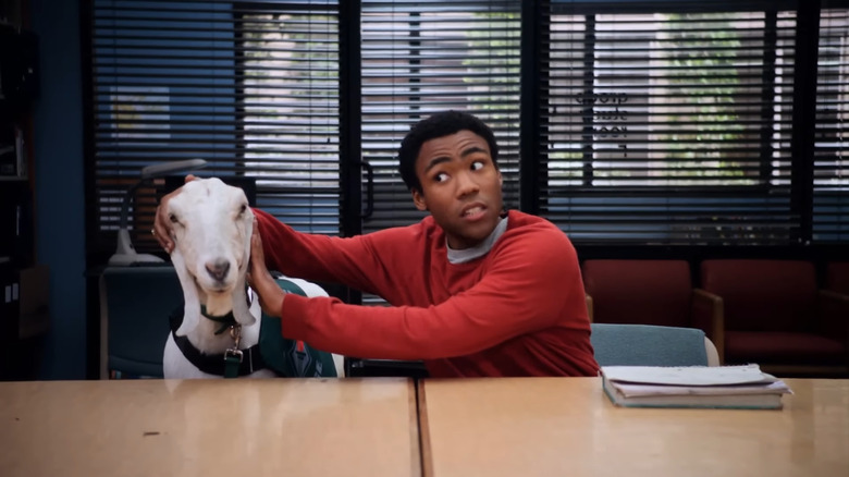 Donald Glover as Troy Barnes petting a goat in Community