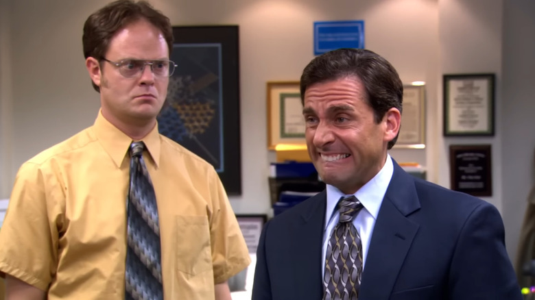 Rainn Wilson's Dwight Schrute looking at Steve Carell's Michael Scott pull a face in The Office