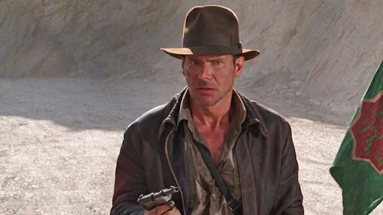 Indiana Jones holding a gun