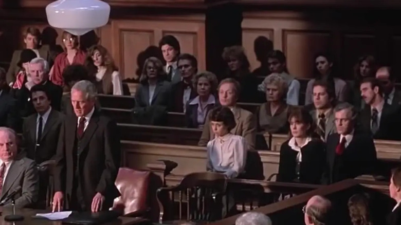 A courtroom scene from The Verdict with Bruce Willis in the background