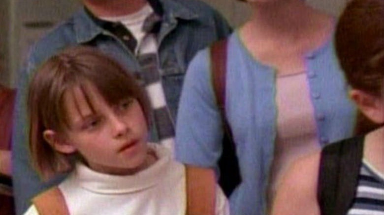 Young Kristen Stewart waiting in a line for a water fountain in The Thirteenth Year