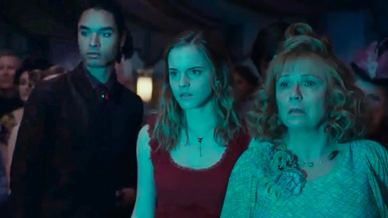 Hermione and Mrs Weasley with a wedding guest in Harry Potter and the Deathly Hallows Part 1