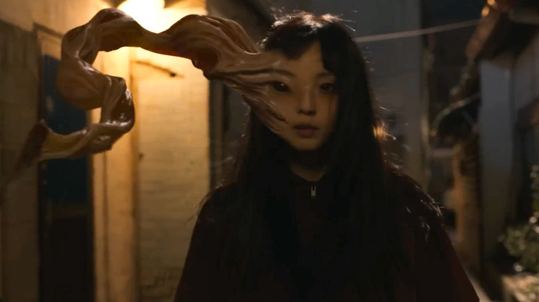 The parasite of Jeong Su-in (Jeon So-nee) emerges from her face in Parasyte: The Grey