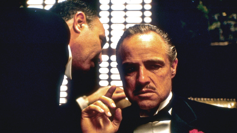 Bonasera whispering to Vito Corleone in The Godfather