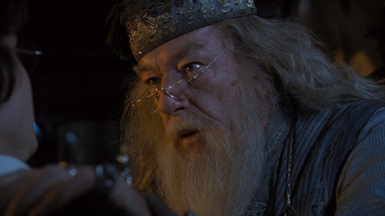 Dumbledore (Michael Gambon) grips Daniel Radcliffe as Harry's shoulder intensely, in Harry Potter and the Goblet of Fire