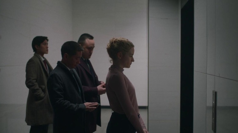 Julia Garner waits for elevator in The Assistant