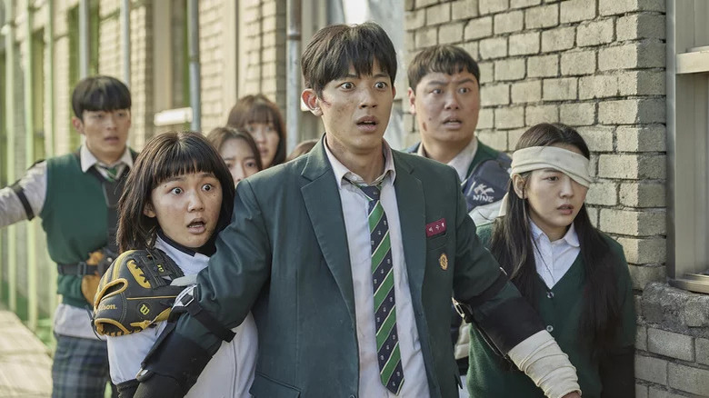 Students in school uniforms standing and looking scared